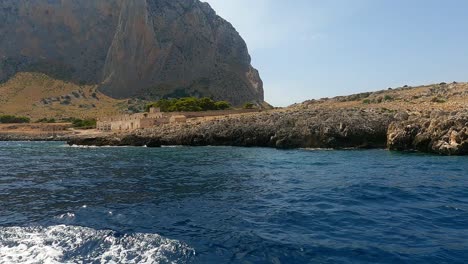 typical old sicilian seafront tonnara del secco used for tuna fishing as seen from boat in sicily