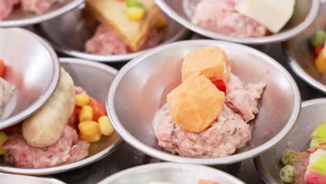 a vibrant display of assorted dim sum dishes in a bustling phuket market, showcasing colorful ingredients and traditional thai flavors