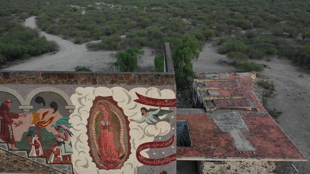 Mural of the Virgin of Guadalupe converting natives into christians in Mexico