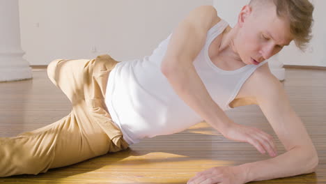 focused young man in casual wear performing a contemporary dance in the studio 1