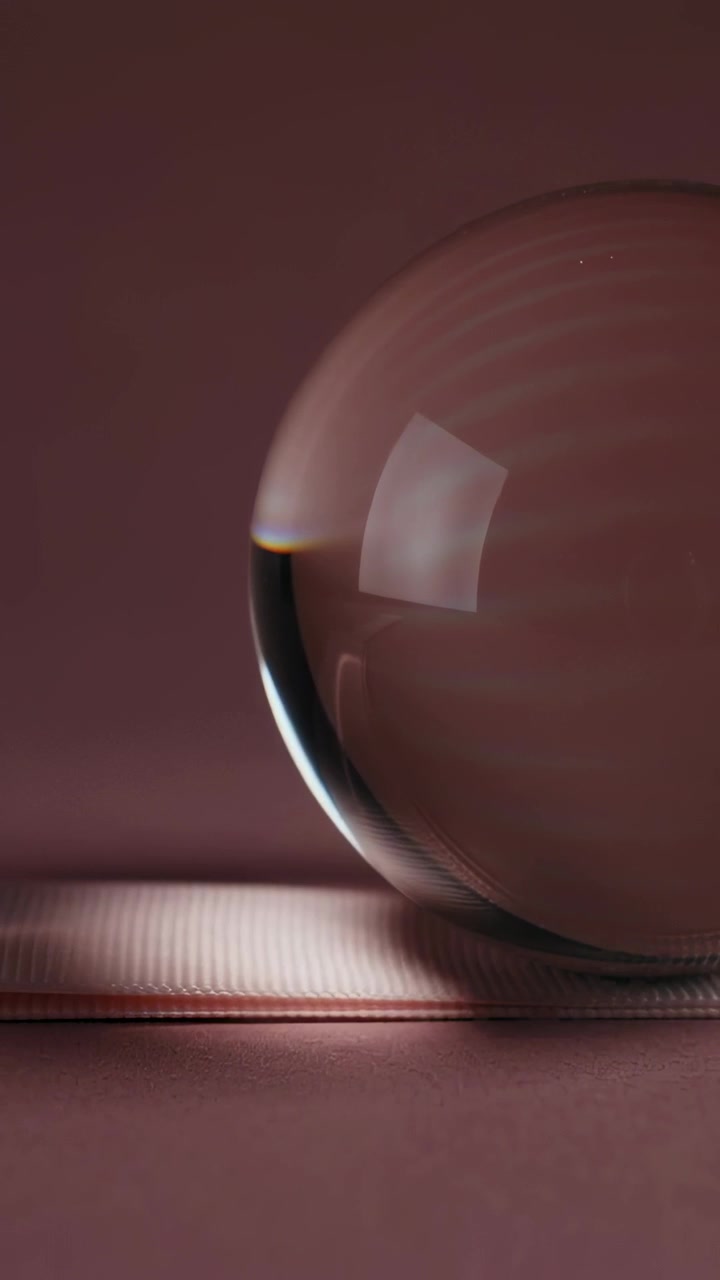 Vertical video: Softbox causing glass sphere rolling on tabletop lighting ribbed mat