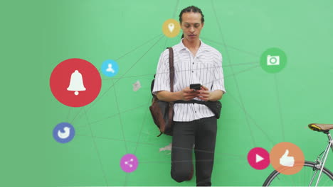 animation of media icons over biracial man using smartphone