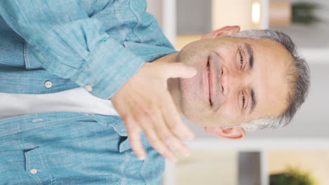 Vertical-video-of-Man-making-positive-gesture-at-camera.