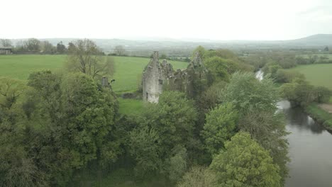 Volar-De-Regreso-Sobre-Las-Ruinas-Del-Castillo-De-Dromaneen-Cerca-Del-Río-Blackwater-En-El-Condado-De-Cork,-Irlanda