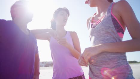 multi ethnic friends summer holiday training on beach