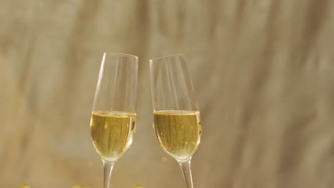 champagne glasses and confetti on green background at new year's eve