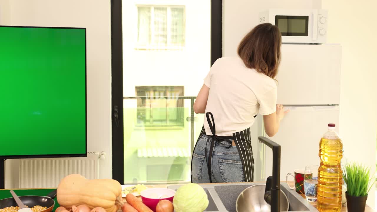 Woman Cooking with Vegetables in Kitchen