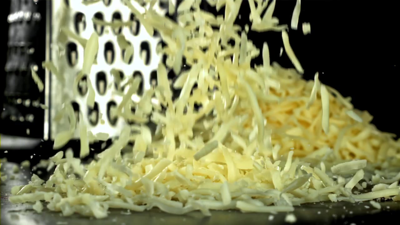Close-up of Grated Cheese Falling in Super Slow Motion