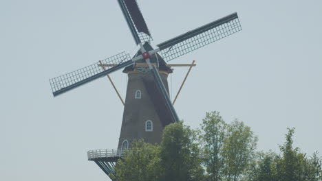 tilt up from hikers to a beautiful classic windmill in the netherlands