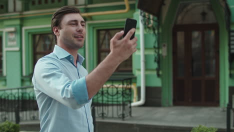 close up view of businessman walking with phone on the street