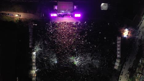 large crowd at a nighttime outdoor concert