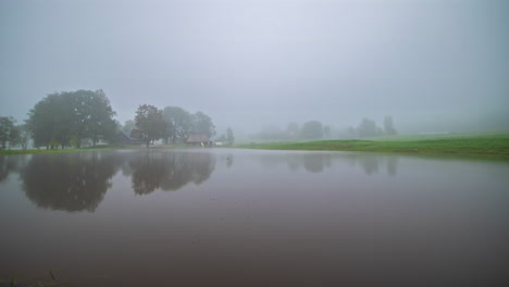 foggy, misty morning at a cabin by a lake - time lapse