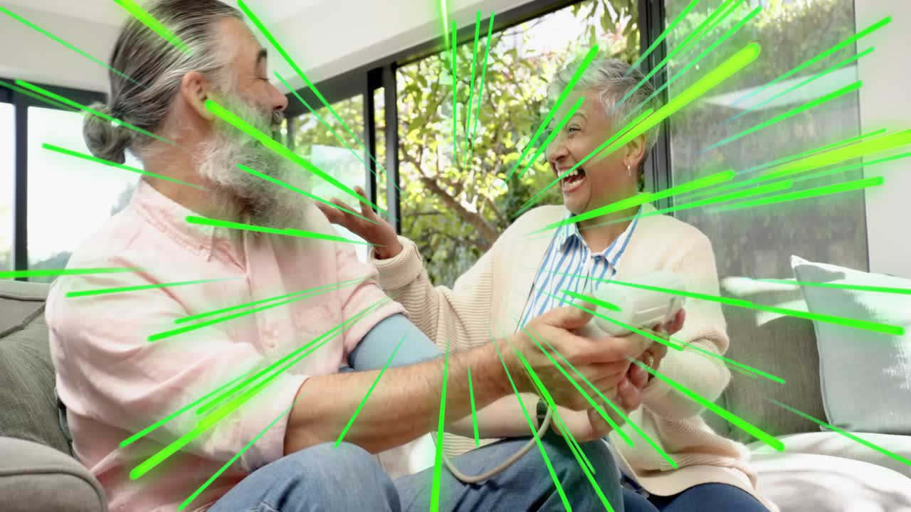 Man guiding woman holding white device on sofa, initiating health demo, green streaks radiating