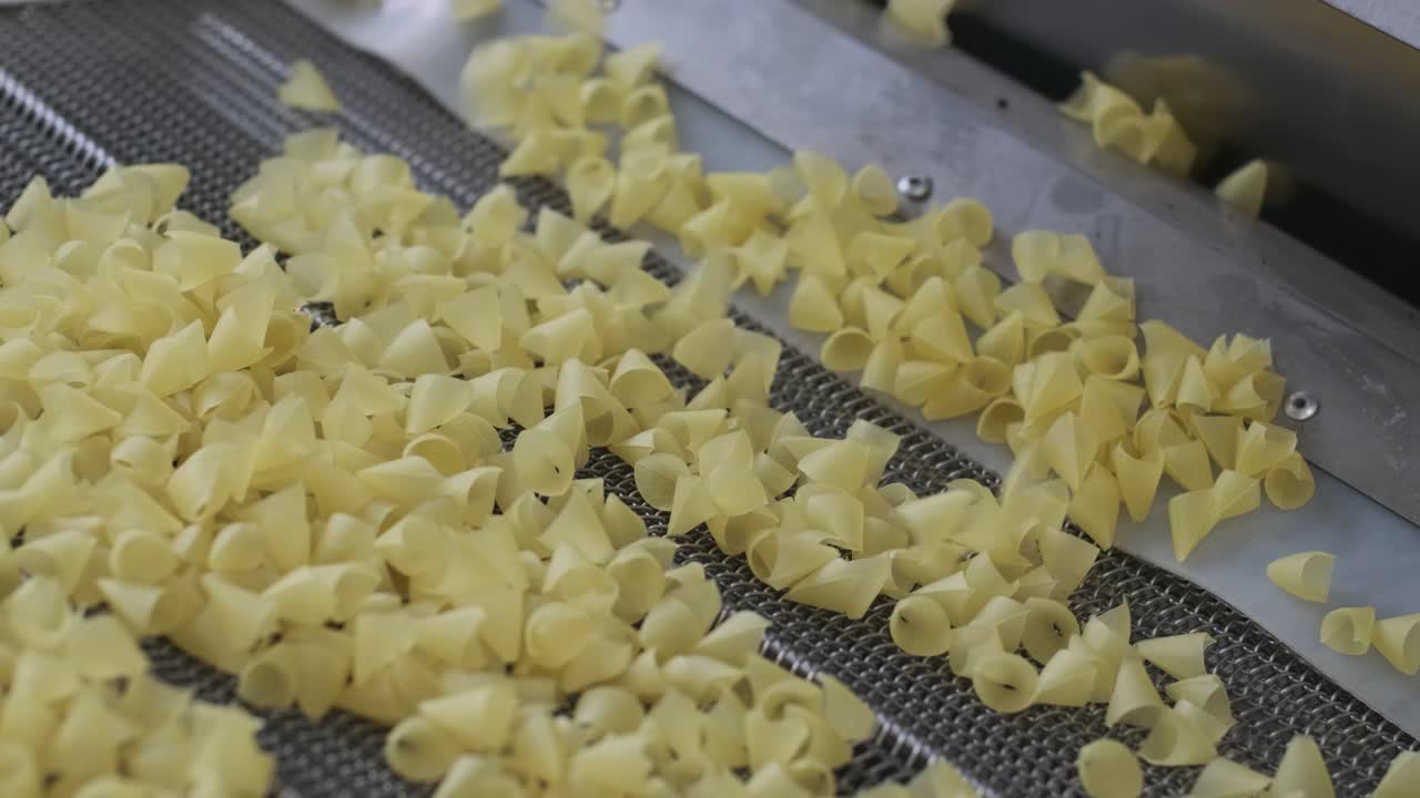 Production factory line moves potato snackes. Production line of the pasta factory, pasta production