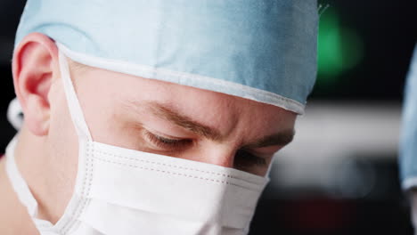 surgeon and medical assistant working, head shot