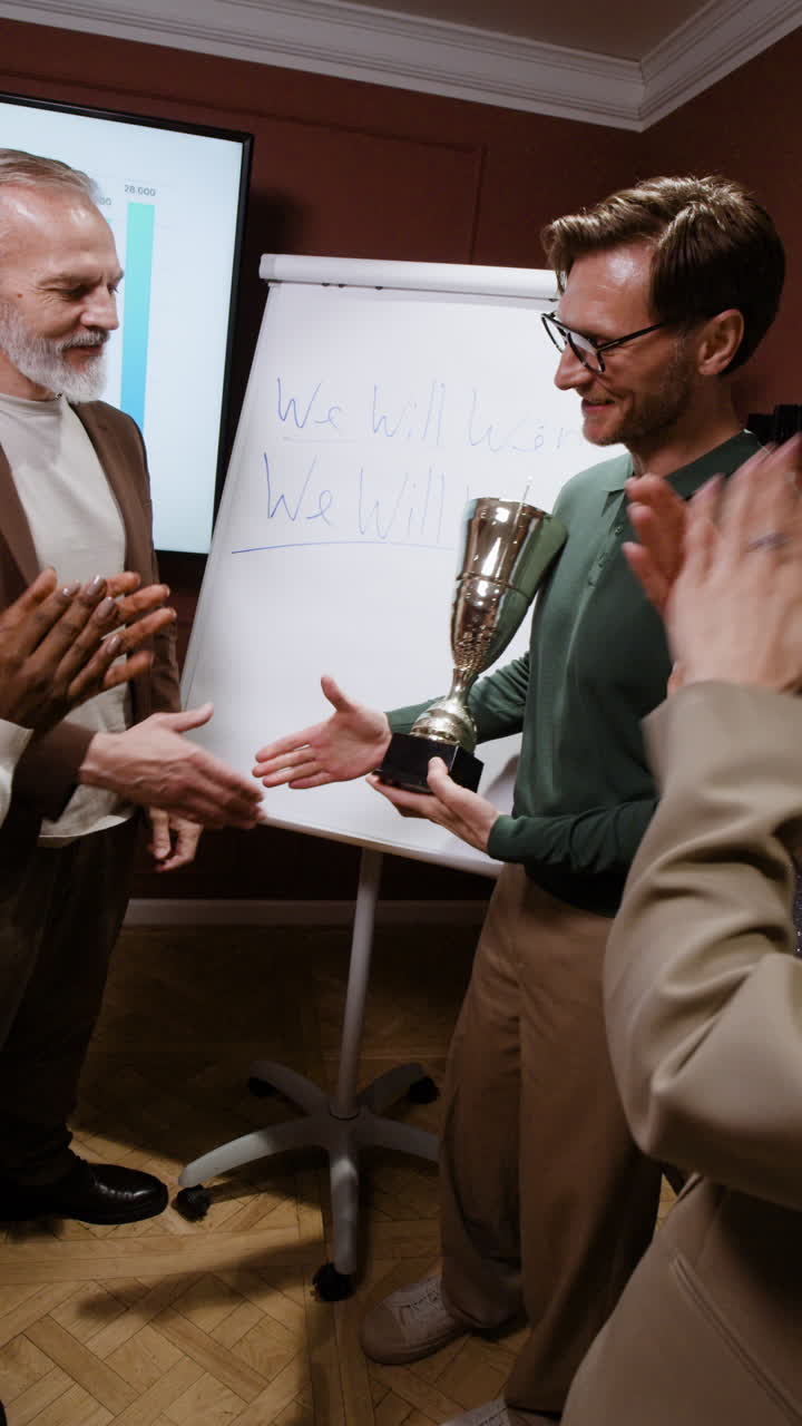 Business Team Celebrating Success with Trophy and Handshake
