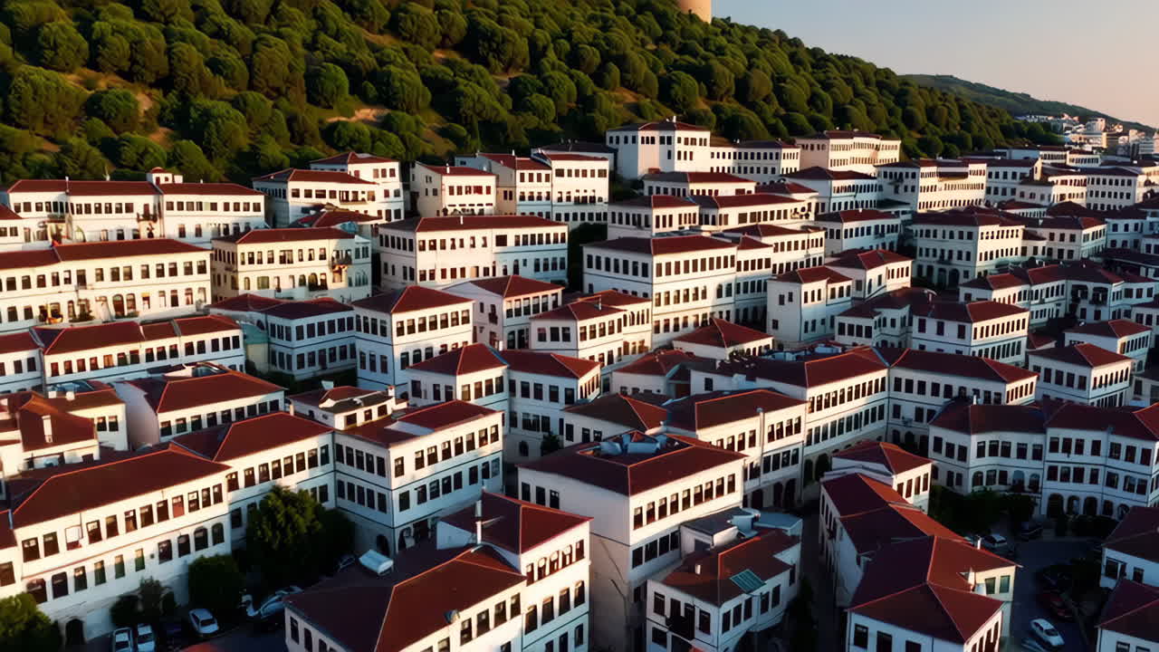 Aerial view of a historic city with a fortress and red-roofed buildings