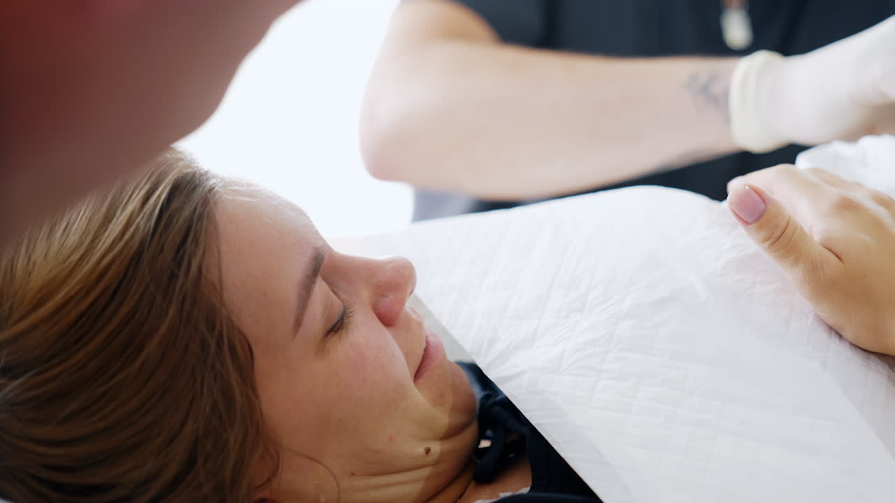 Happy first time mom crying holding a newborn on her chest. Happiness of a woman right after labor. Close up.