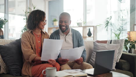 happy couple reviewing bills at home