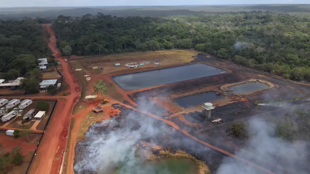 Aerial clip of a wild grass fire and smoke at the edge of a remote community in Cape York, Australia. Clip 2