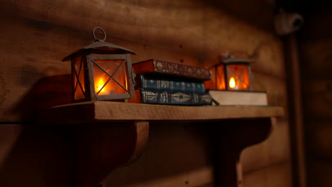 cozy rustic scene with lanterns and books on wooden shelf