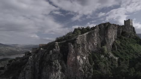 4k drone overflight of zahara de la sierra, spain, filmed with a dji at 30fps. a cinematic reveal of the village, its historic castle, and the breathtaking zahara reservoir.