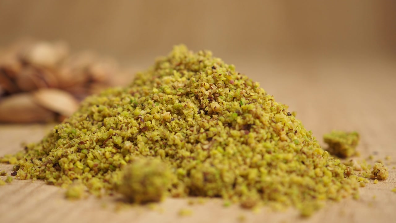 Pile of Ground Pistachios on a Wooden Surface