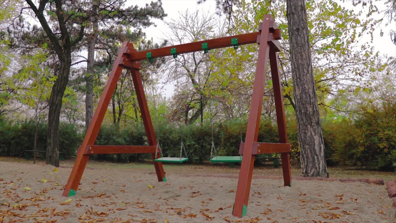 Empty Swing Set in an Autumn Park