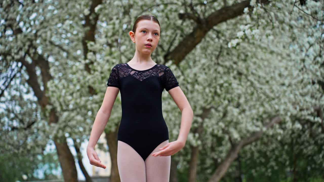 Young Ballerina Practicing in a Spring Park