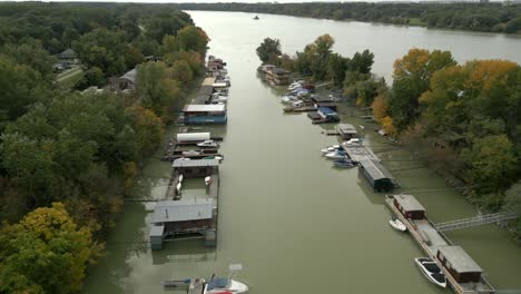 aerial shot of houseboats on danube river in bratislava capital of slovakia, autumn