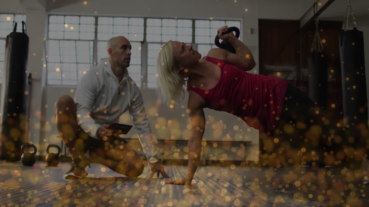 Training with kettlebell, person exercising with golden particles animation