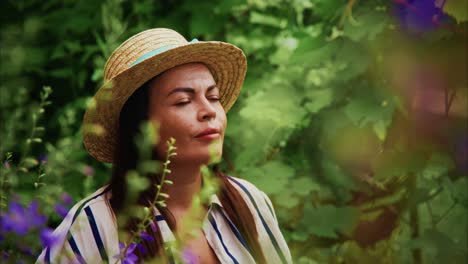 woman enjoying nature in a lush garden surrounded by vibrant flowers and greenery