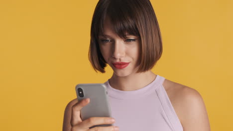 young woman with red lips using smartphone