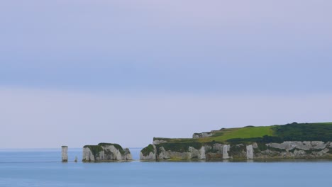 old harry rocks with white chalk cliffs on english coastline with blue calm sea near poole, dorset uk 4k