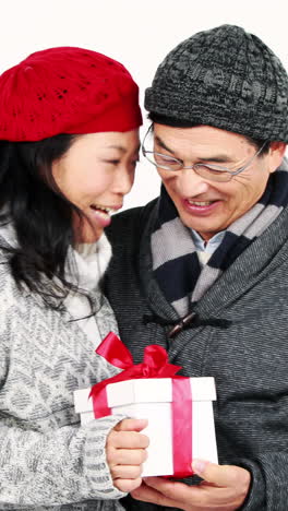 happy asian couple holding a present