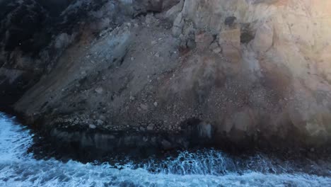 waves crashing against a wall of dirt