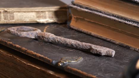 rusty key and old books evocating religious concept about life