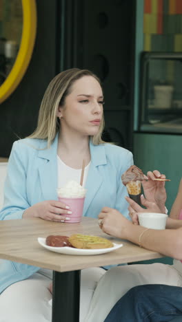 wide shot of a group of friends chatting animatedly at an ice cream shop. a relaxed, youthful, and authentic scene that conveys friendship, connection, and enjoyment.