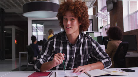 Happy-mixed-race-businessman-having-video-call-sitting-in-front-of-computer