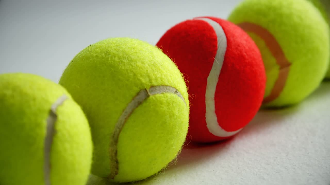 Tennis balls arranged in row 4k