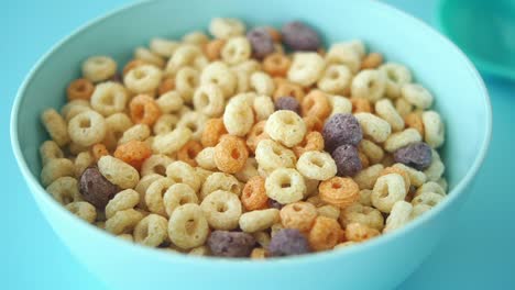 a bowl of cereal with milk pouring in