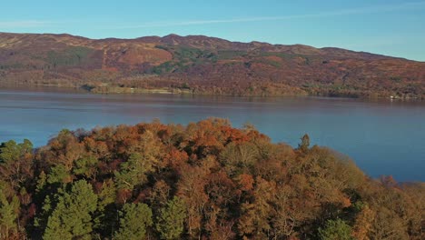 scenic aerial panoramic orbital views across lock lamond lake during autumn in scotland