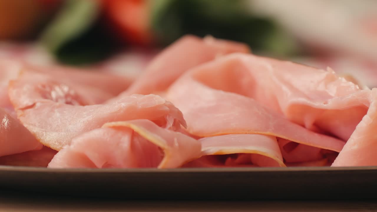 Ham italian mordatella, man Slices Of Traditional Italian antipasti mortadella sausage on a wooden cutting board, close up macro of chicken or turkey jamon, fat breakfast dish.