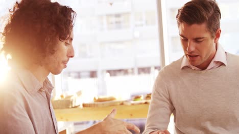 two men shaking a hands in cafe