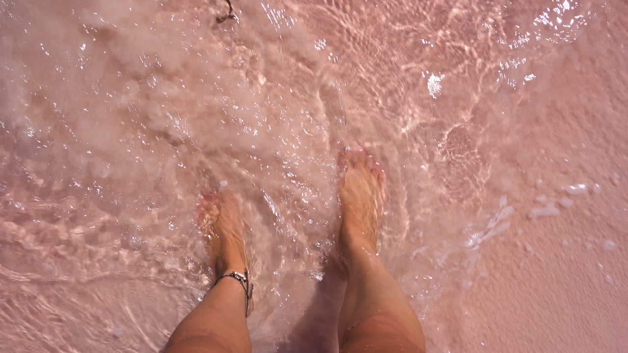 Person On Pink Sandy Beach On Komodo Island In Bali, Indonesia. - POV