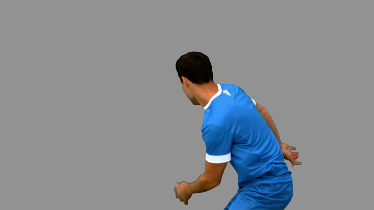 Jogador de futebol bonito aquecendo em tela cinza.