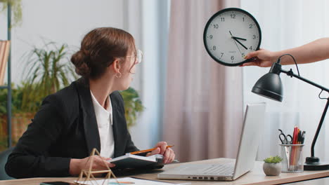 young businesswoman with anxiety checking time on clock running late to work being in delay deadline