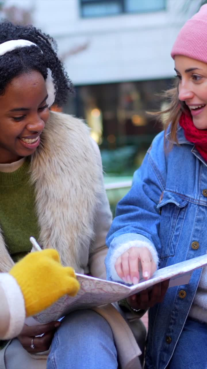 Friends looking at a map outdoors