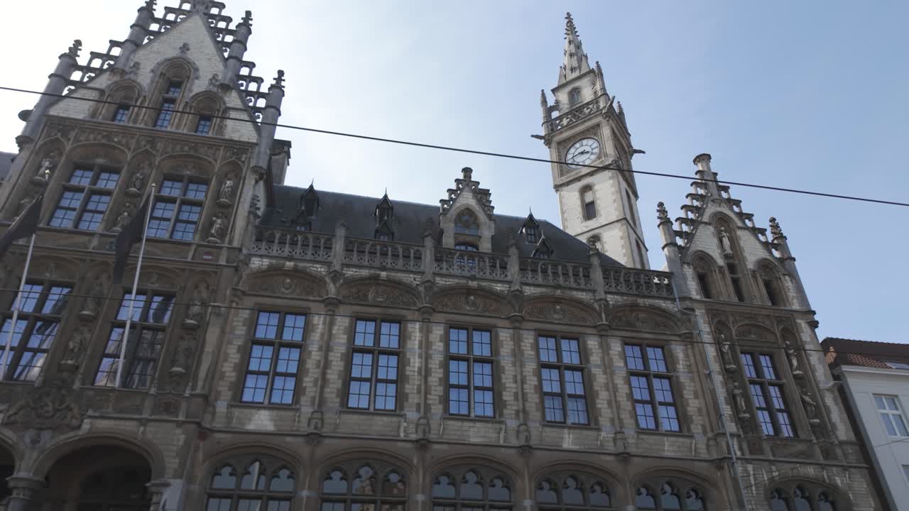 Historic neo Gothic facade with clock tower of Shopping Centre De Post in Ghent Belgium