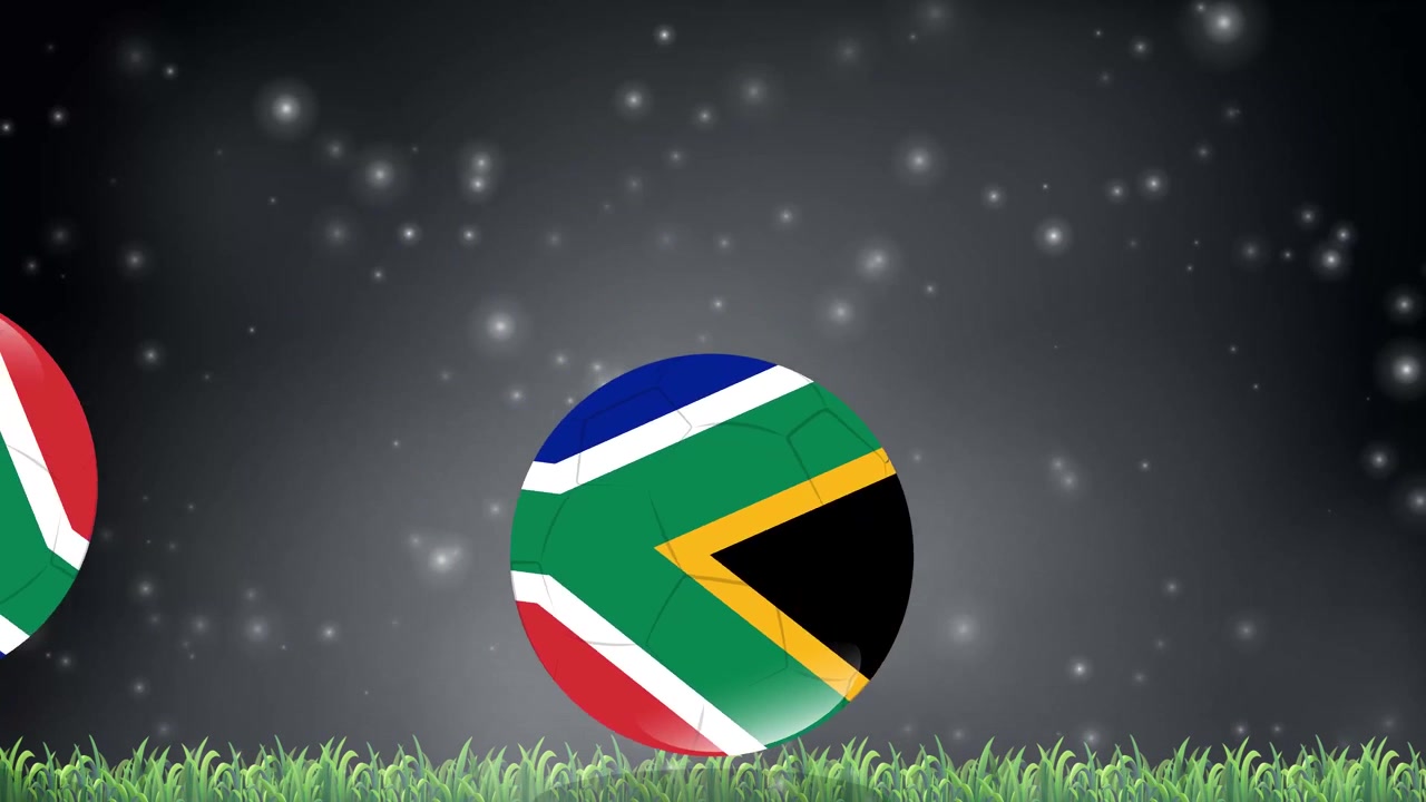 Palloni da calcio animati con motivi della bandiera sudafricana rimbalzano sull'erba sotto particelle luminose